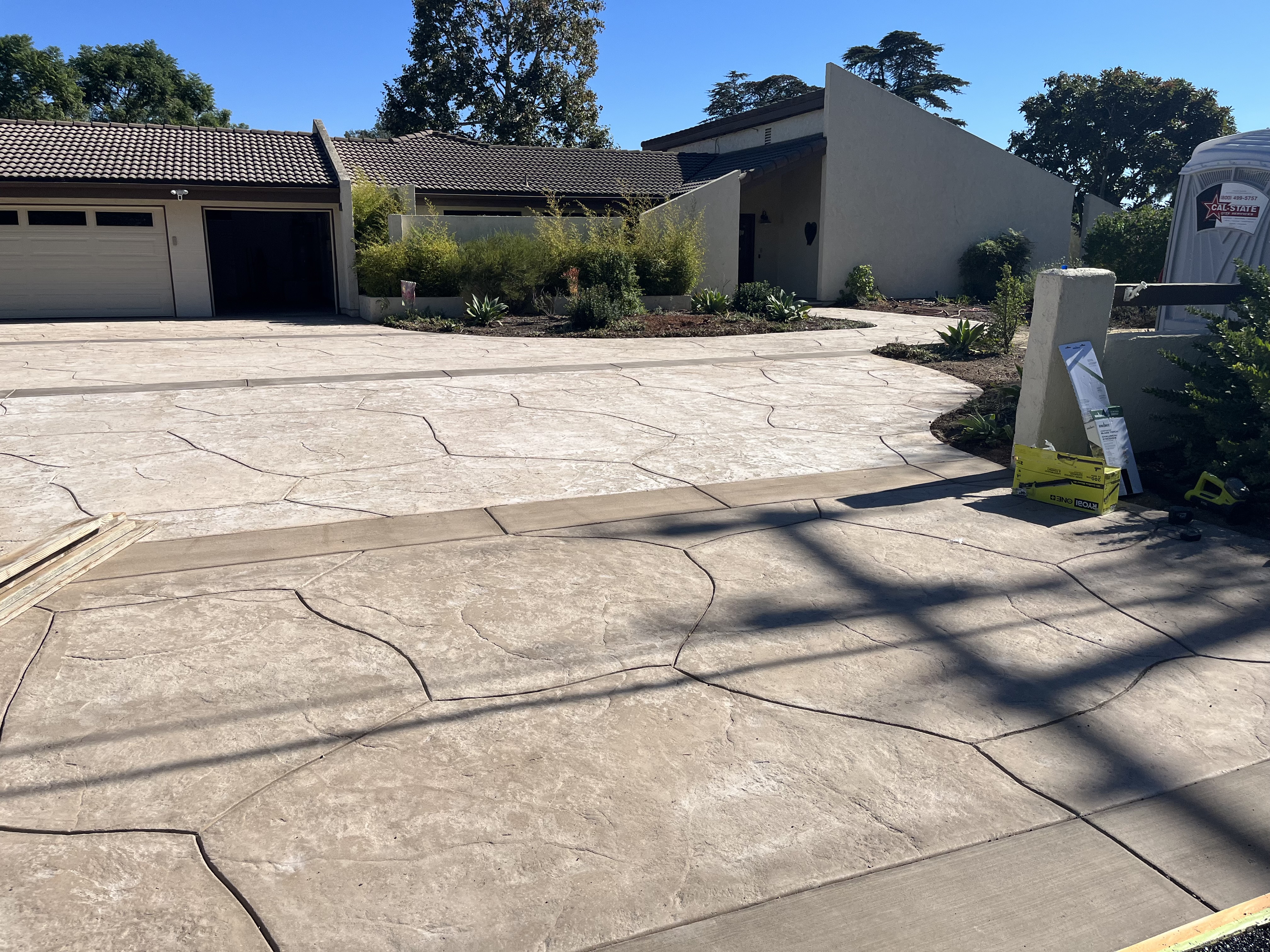 Stamped flagstone driveway with tropical landscaping