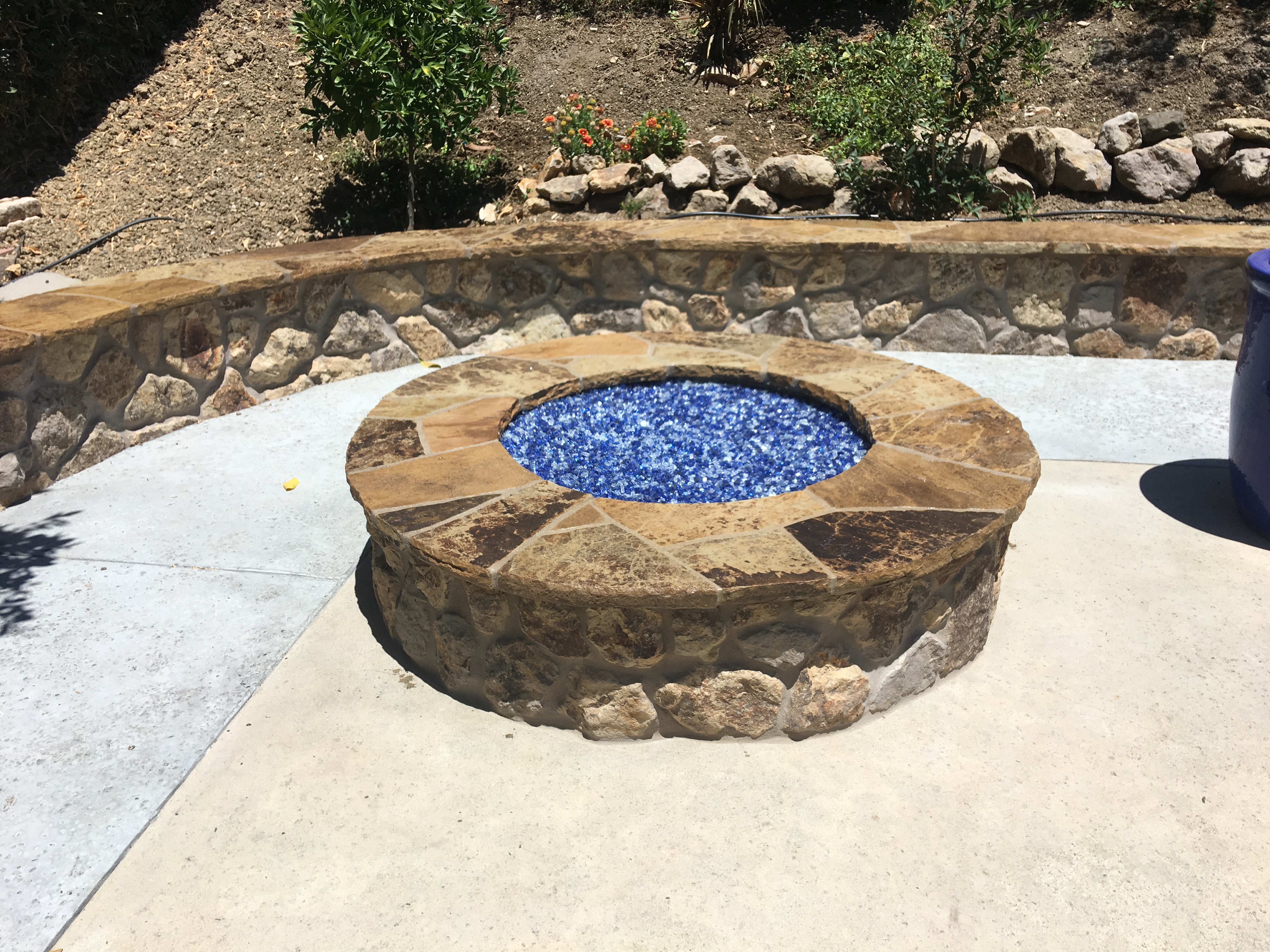 Stone fire pit with blue glass media