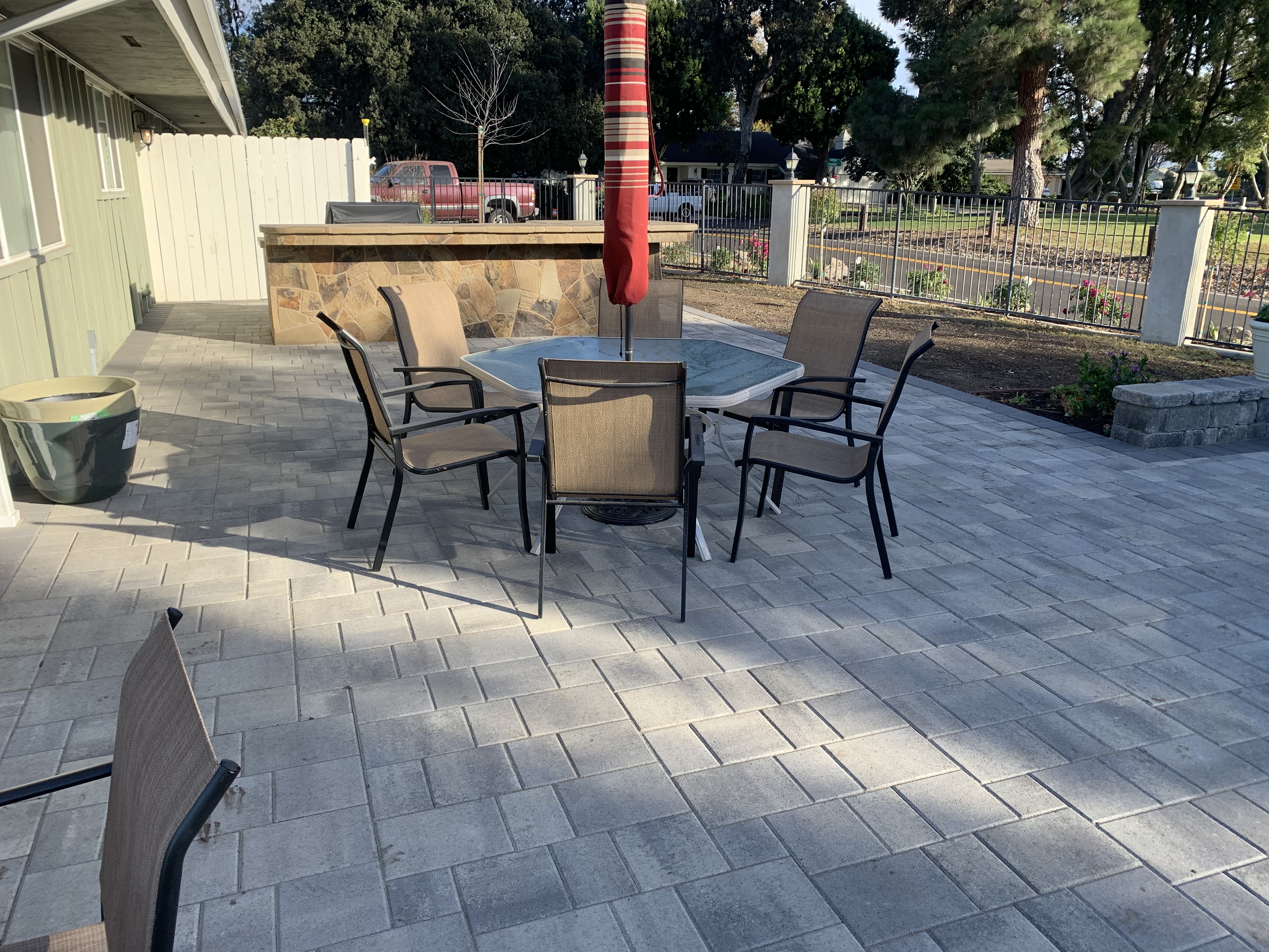 Paver patio with outdoor kitchen and dining area